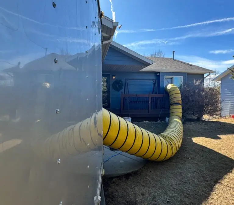 Drier leading into window of home with water damage