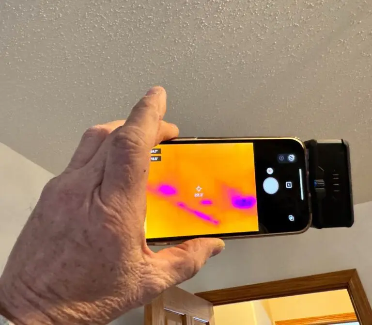 Rapid Rescue worker searching for water damage with a thermal image camera